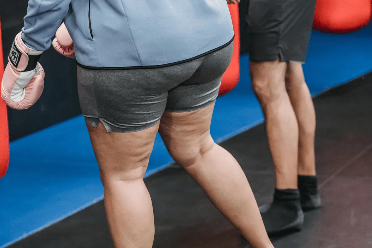 Close-up of individuals at a gym engaging in boxing training.