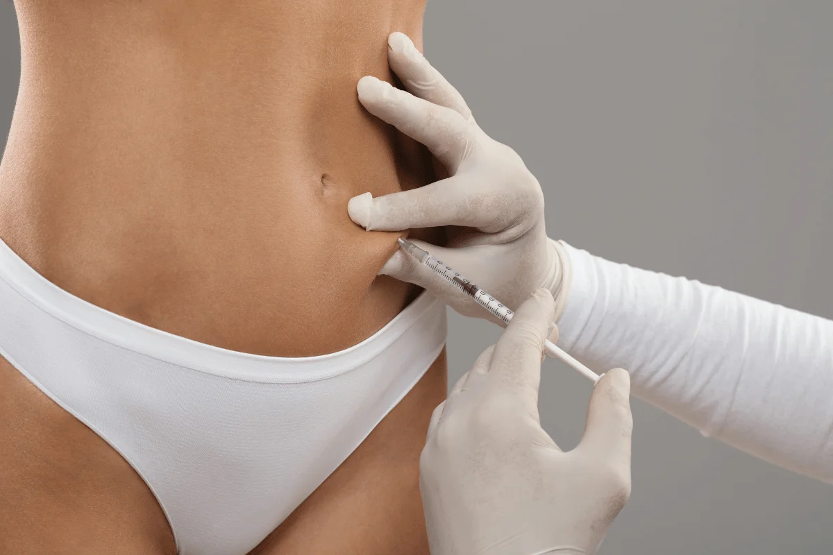 Health procedure showing a syringe injection into the lower abdomen area.