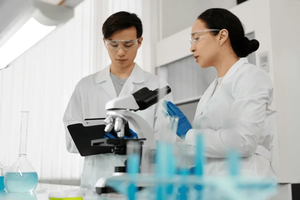 Two scientists discussing research findings in a laboratory setting.