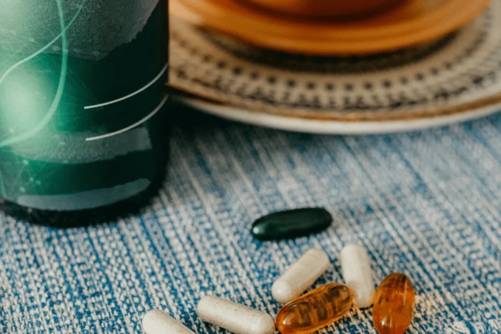 Close-up of dietary supplements and capsules on a table.