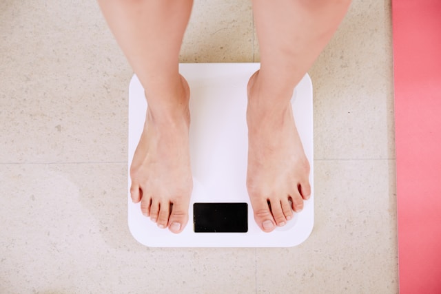 Woman standing on digital weight scale