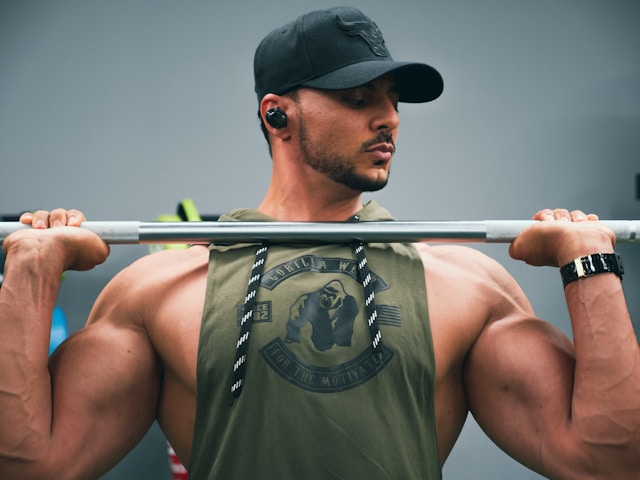 Bodybuilder performing an overhead press in the gym
