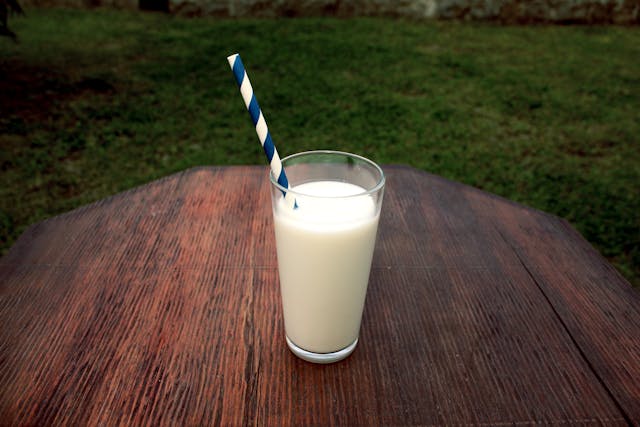 Glass of milk with a straw in it