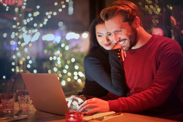 Happy couple researching information online