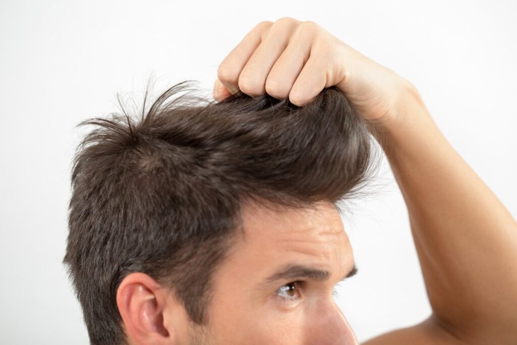A man holding his hair